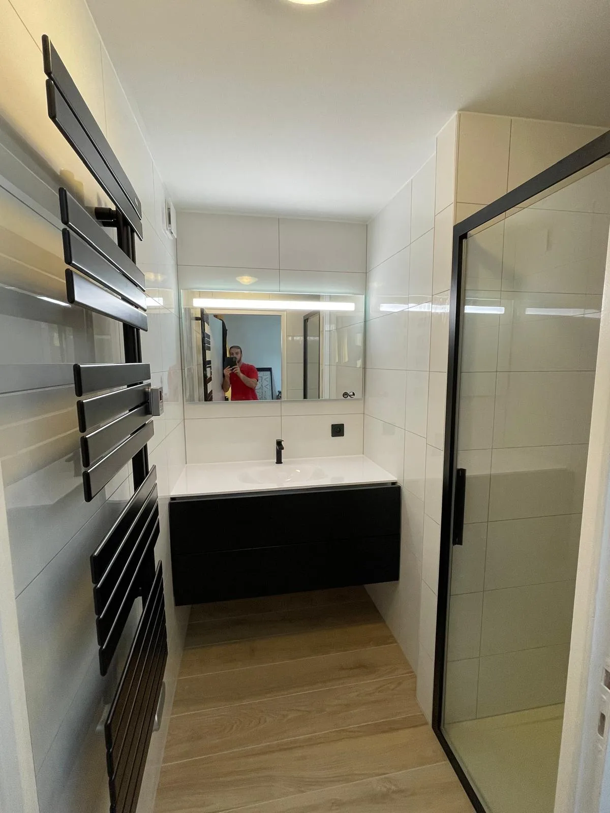 Sèche-serviettes noir, meuble vasque et miroir lumineux